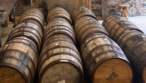 whisky barrels lined up in a warehouse at Nc'nean distillery in Morvern