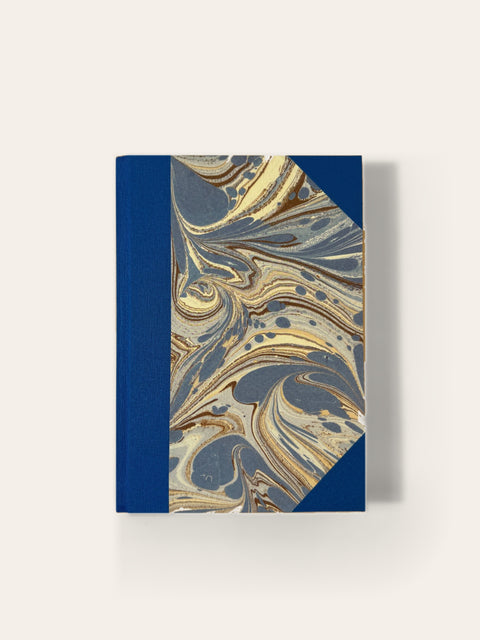 Hand-bound A5 notebook with royal blue cloth and blue and gold marbled paper cover, ruled pages, Sisu Stationery