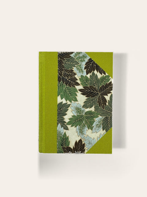 Hand-bound A6 pocket notebook with lime cloth and green botanical leaf paper cover, ruled pages, Sisu Stationery