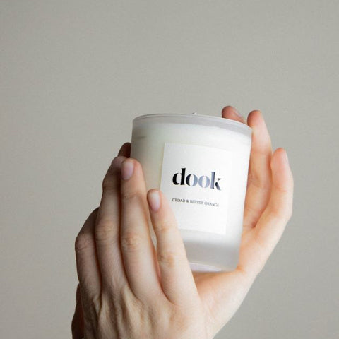 Dook's candle being held in two hands.