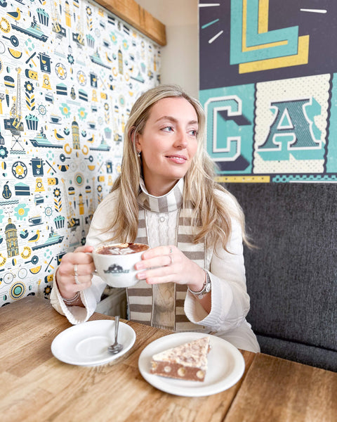white woman wearing beige and cream skinny merino wool stripe scarf - Woolkind