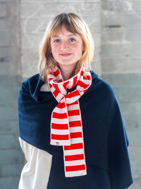 white woman wearing red and cream skinny merino wool stripe scarf - Woolkind