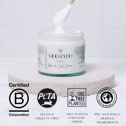 Jar of curl cream with a spatula, labeled 'Moo & Yoo', on a white background with certification logos displayed.