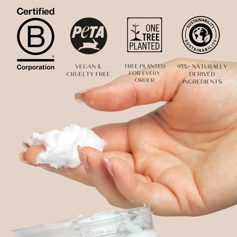 Hand holding a small amount of hair mask with sustainability certification logos on a beige background